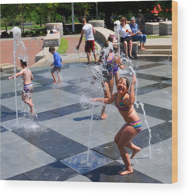 Child Playing In Water Fountain Wood Print featuring the photograph Joyful Young Girl Playing in Fountain by Ginger Wakem