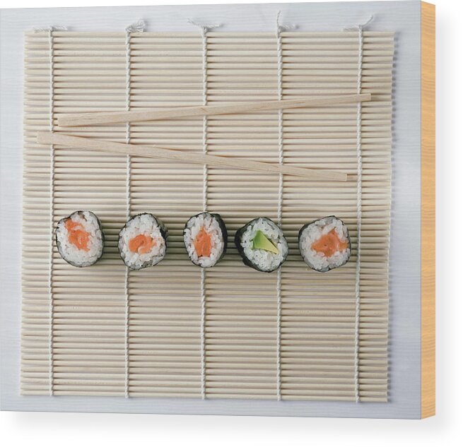 White Background Wood Print featuring the photograph Sushi And Chopsticks On A Wooden Mat by Larry Washburn