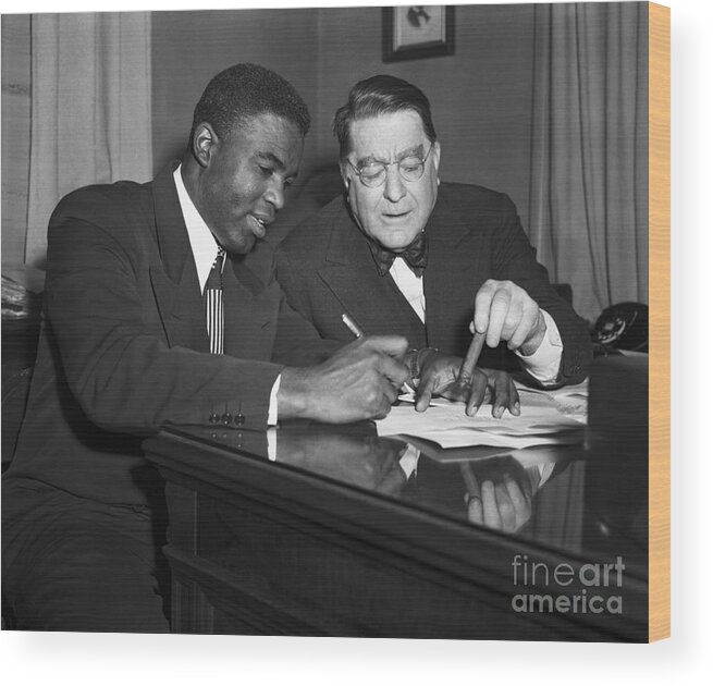 Mature Adult Wood Print featuring the photograph Jackie Robinson Signing Contract by Bettmann