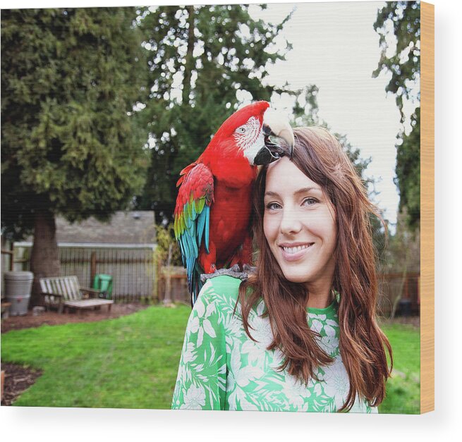 Beautiful Woman Wood Print featuring the photograph Portrait Of Beautiful Woman With Scarlet Macaw by Cavan Images