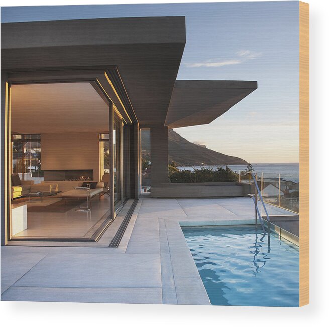 Tranquility Wood Print featuring the photograph Modern living room and patio next to swimming pool by Martin Barraud