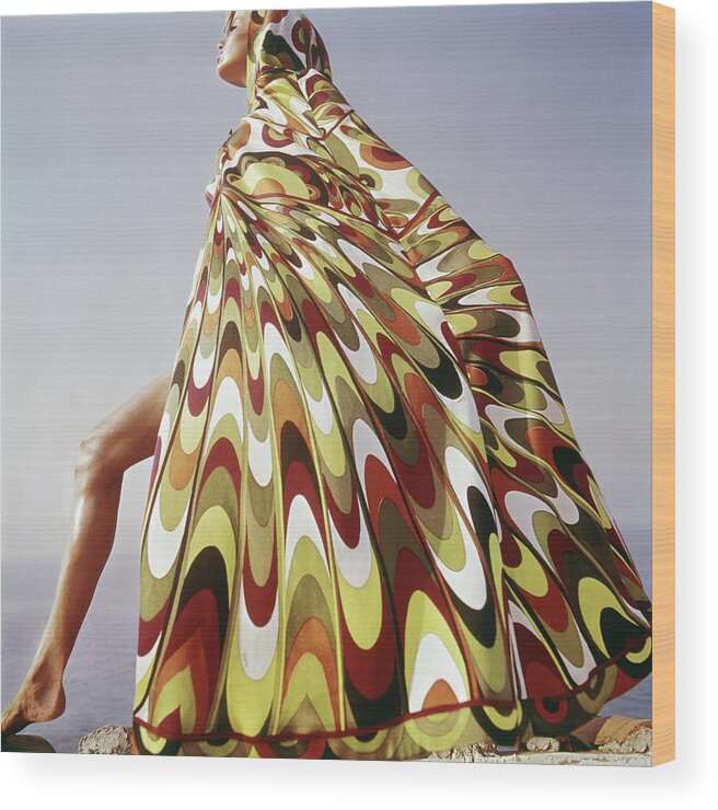 Exterior Fashion Lifestyle Outdoors Daytime Side View One Person People Female Model Young Woman Young Adult Young Adult Woman Lake Tanganyika Colorful Cover-up Emilio Pucci Pucci Africa Posing 1960s Style #condenastvoguephotograph January 1st 1965 Wood Print featuring the photograph A Model Posing In A Colorful Cover-up by Henry Clarke