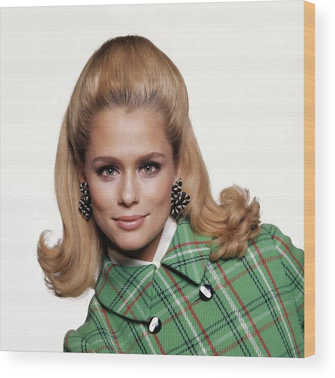 Fashion Wood Print featuring the photograph Laura Hutton Wearing A Coat And Earrings by Bert Stern
