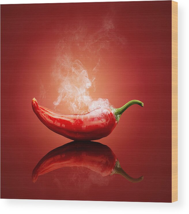 Chillichiliredsmokesmokinghotburnburningsteamsteamingcapsicumcayennejalapenopaprikapeppergradientbackgroundreflectionreflectivetablestudioshotvegetablefreshconceptconceptualstilllifefoodripeimageonenobodyphotographindoors001019xs Wood Print featuring the photograph Steaming hot Chilli by Johan Swanepoel