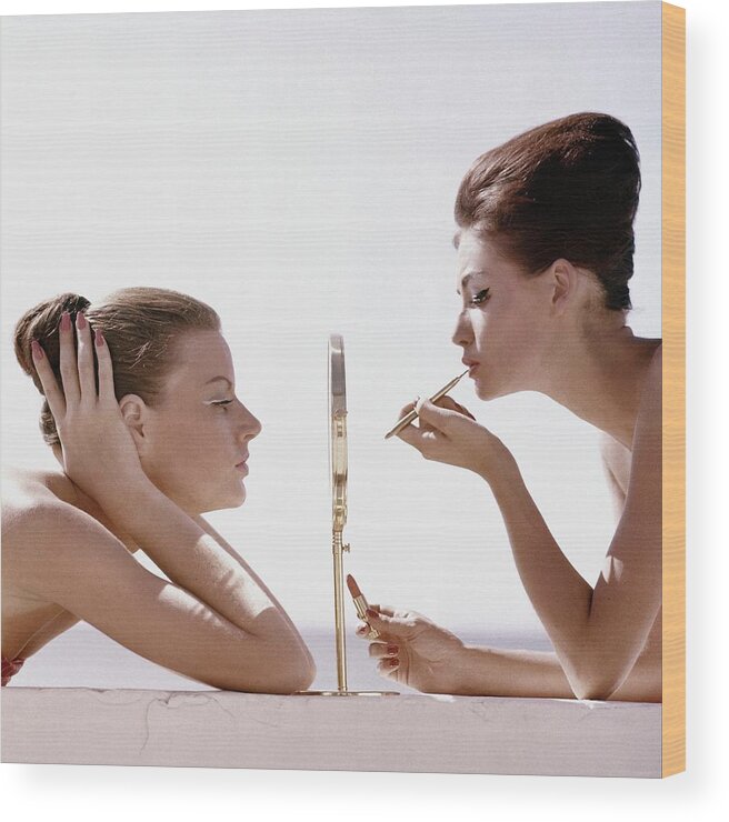 Beauty Studio Shot Two People People Mirror Reflection Applying Lipstick Make-up Cosmetics Max Factor White Background Leaning Lip Brush 20-24 Years Young Adult 20s Adult Female Young Woman Young Adult Woman #condenastvoguephotograph April 1st 1960 Wood Print featuring the photograph Women With A Mirror by Leombruno-Bodi