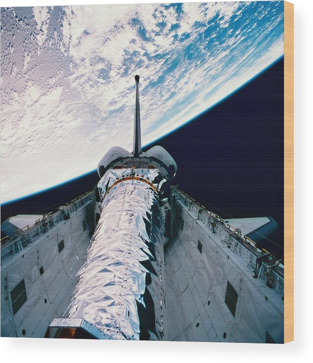 Square Wood Print featuring the photograph The Space Shuttle With Its Open Cargo Bay Orbiting Above The Earth by Stockbyte