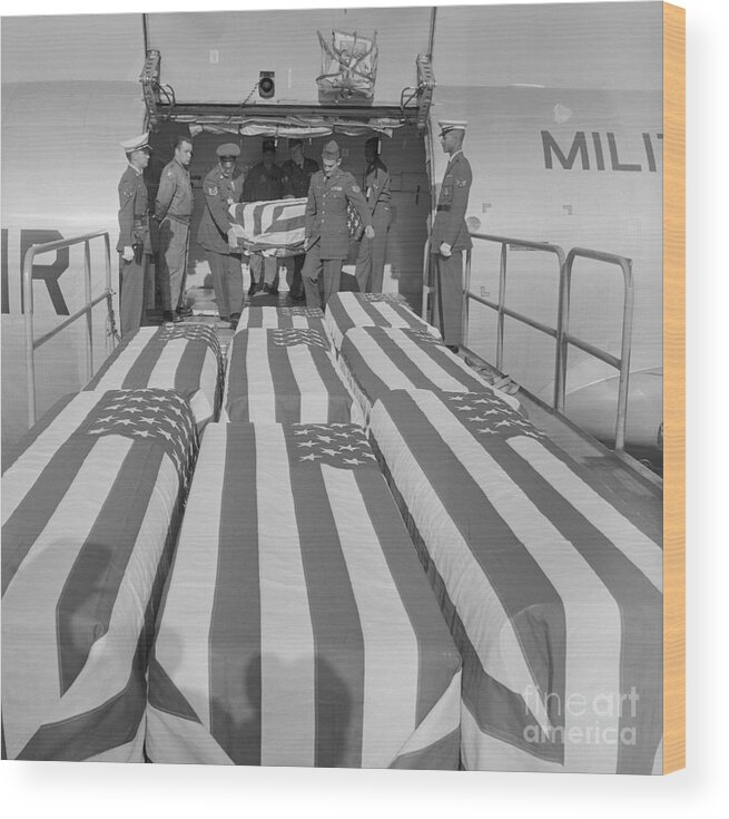 Vietnam War Wood Print featuring the photograph American Flag Covered Caskets by Bettmann
