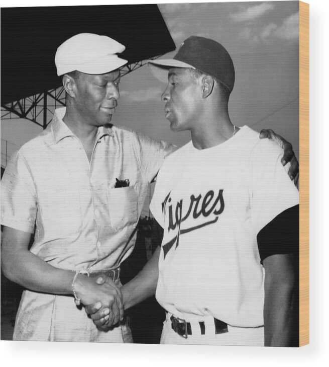 1950-1959 Wood Print featuring the photograph Nat King Cole And Minnie Minoso by Michael Ochs Archives
