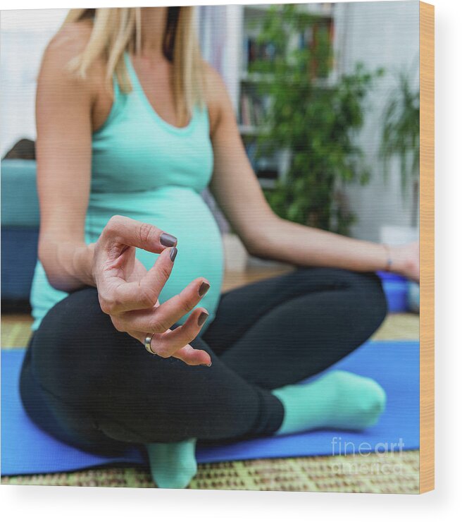 Pregnancy Wood Print featuring the photograph Pregnant Woman Doing Yoga At Home by Microgen Images/science Photo Library