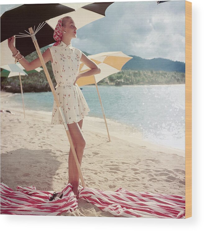 Home Sewn Wood Print featuring the photograph Model Standing Under a Beach Umbrella by Roger Prigent