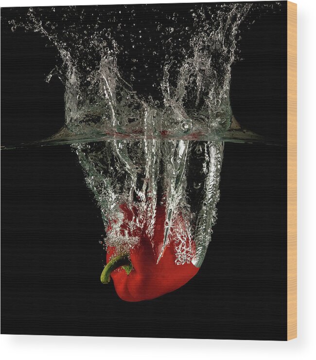 Pepper Wood Print featuring the photograph Red bell pepper dropped and slashing on water by Michalakis Ppalis