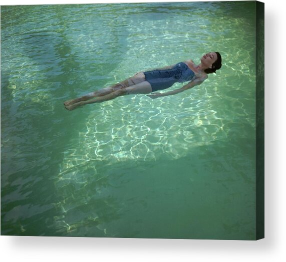 A Model Floating In A Swimming Pool Acrylic Print