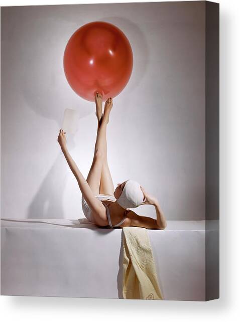 A Model Balancing A Red Ball On Her Feet Canvas Art Print by Horst P Horst