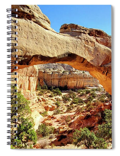 https://render.fineartamerica.com/images/rendered/medium/front/spiral-notebook/images/artworkimages/medium/3/photo-of-hickman-bridge-capitol-reef-national-park-by-traveling-artist-and-blogger-meganaroon-megan-aroon.jpg?orientation=1&targetx=-711&targety=-1&imagewidth=2026&imageheight=961&modelwidth=680&modelheight=961&backgroundcolor=462E1A&producttype=spiralnotebook