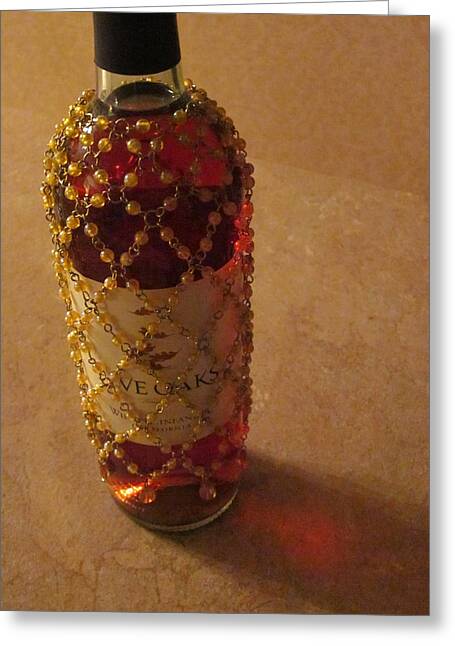 The White Wine Bottle In Its Netting Casts A Red Ethereal Glow On The Greeting Cards