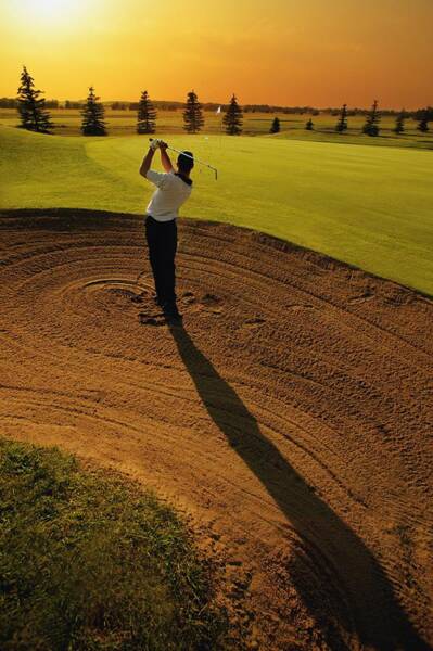 Wall Art - Photograph - Golfer Taking A Swing From A Golf Bunker by Darren Greenwood