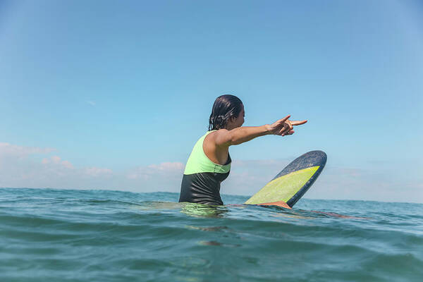 Wall Art - Photograph - Female Surfer Sitting On Surfboard by Cavan Images