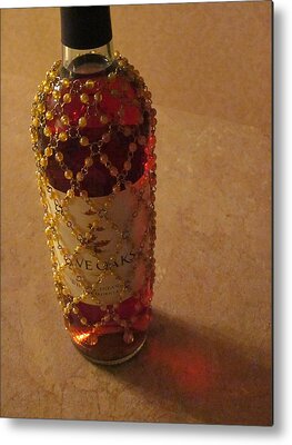 The White Wine Bottle In Its Netting Casts A Red Ethereal Glow On The Metal Prints