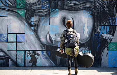 Young Man Staring At Graffiti Wall Posters