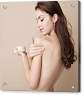 A Woman Rubbing Lotion On Her Naked Arm Acrylic Print