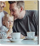 Gay Couple Cuddling With Their Baby In Cafe Acrylic Print