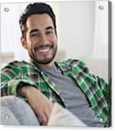 Mixed Race Man Smiling On Sofa Acrylic Print