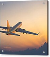Passenger Airplane Flying Above Clouds During Sunset Acrylic Print