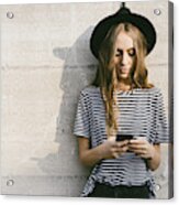 Portrait of fashionable young woman wearing hat using smartphone Acrylic Print