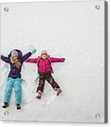 Two Sisters Playing, Making Snow Angels Acrylic Print