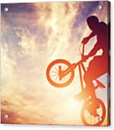 Man Riding A Bmx Bike Performing A Trick Against Sunset Sky Acrylic Print