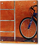 Bicycle Against Orange Wall Acrylic Print