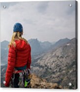 Female Hiker With Mountain Climbing Equipment Looking At View While Standing On Cliff Against Sky Acrylic Print