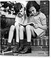 Young Boy & Girl Reading A Book Outdoors Acrylic Print
