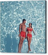 Young Couple Jumping In Swimming Pool Acrylic Print