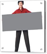 An Adult Asian Woman In A Dark Grey Pants With A Red Blouse Holds A Large Sign In Front Of Herself Acrylic Print