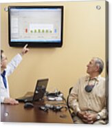 Audiologist Explaining Diagrams For A Patient Wearing Hearing Device Programmer Acrylic Print