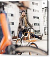 Carefree Woman With Man Riding Bicycle In The City Acrylic Print