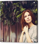 Caucasian Woman Standing Under Leaves By Fence Acrylic Print