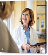 Doctor Discussing With Woman At Nursing Home Acrylic Print