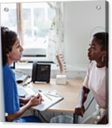 Female Healthcare Worker Explaining Medical Records To Young Patient In Office Acrylic Print