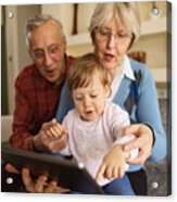 Grandparents And Grandchild Using Digital Tablet At Home Acrylic Print
