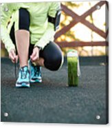 Green Detox Smoothie Cup And Woman Lacing Running Shoes Before Workout. Acrylic Print