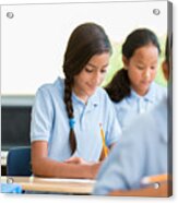 Hispanic Schoolgirl Concentrates While Working On Class Assignment Acrylic Print