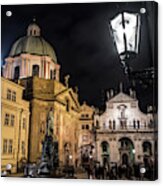 Historic Buildings Beneath The Tower Of Charles Bridge In The Night In Prague In The Czech Republic Acrylic Print