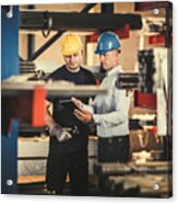 Male Manager And Metal Worker Cooperating While Using Touchpad In A Warehouse. Acrylic Print
