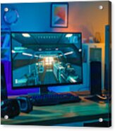 Powerful Personal Computer Gamer Rig With First-person Shooter Game On Screen. Monitor Stands On The Table At Home. Cozy Room With Modern Design Is Lit With Warm And Neon Light. Acrylic Print
