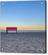 Red Empty Bench At The Beach At Sunset, Sand In Foreground And Ocean In Backround Acrylic Print