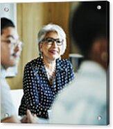 Smiling Mature Female Business Owner Listening During Presentation During Meeting In Office Conference Room Acrylic Print