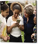 Three Generation Mixed-race Family Looking At Mobile Phone Backyard. Acrylic Print