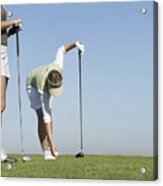 Two Women Standing On A Putting Green, One Picking Up A Golf Ball Acrylic Print